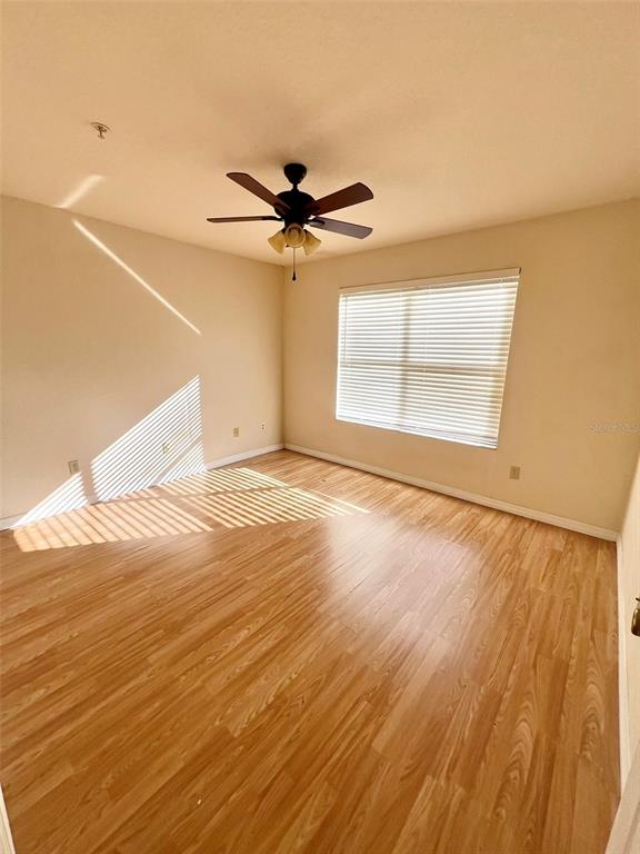 824 Camargo Way, Unit 211 Altamonte Springs, FL 32714 - Photo 9 of 24 an empty room with wooden floor and windows