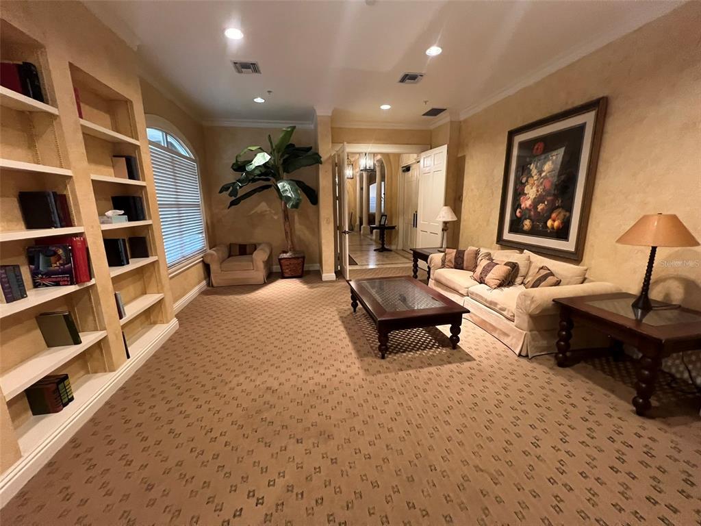 824 Camargo Way, Unit 211 Altamonte Springs, FL 32714 - Photo 10 of 24 a living room with furniture a rug and a book shelf