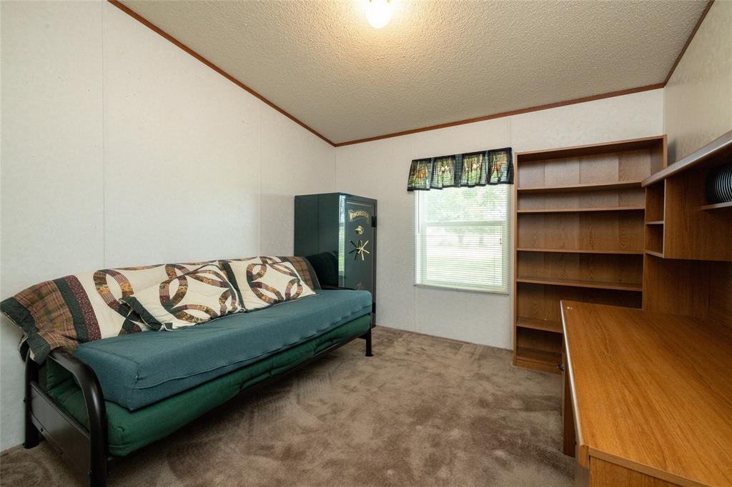 207 Lazy B Lane Springtown, TX 76082 - Photo 26 of 39 Sitting room featuring a textured ceiling, carpet flooring, and crown molding