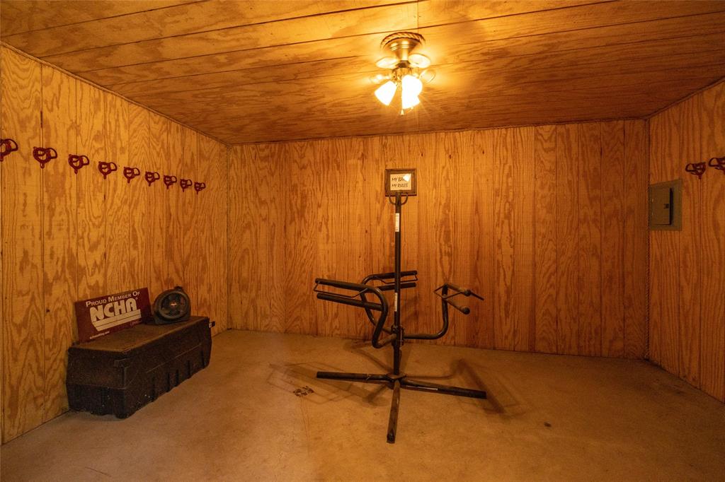 207 Lazy B Lane Springtown, TX 76082 - Photo 33 of 39 Basement with carpet flooring, wood walls, and wooden ceiling