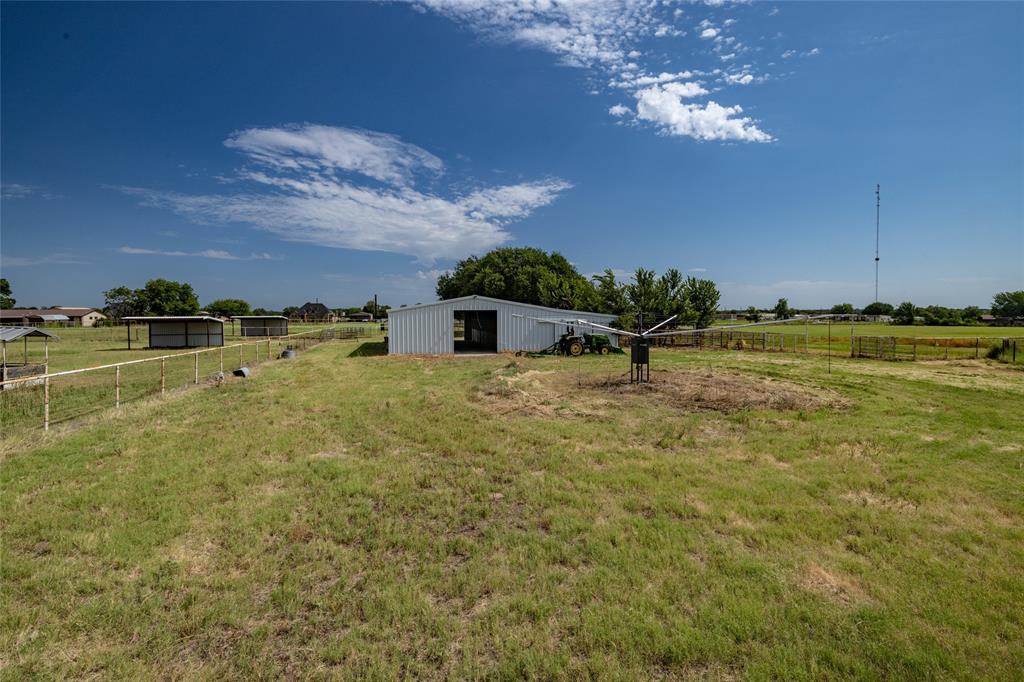 207 Lazy B Lane Springtown, TX 76082 - Photo 36 of 39 View of yard with a rural view and an outdoor structure