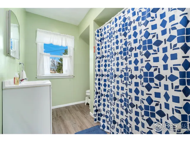 a bathroom with a black and white checkered floor