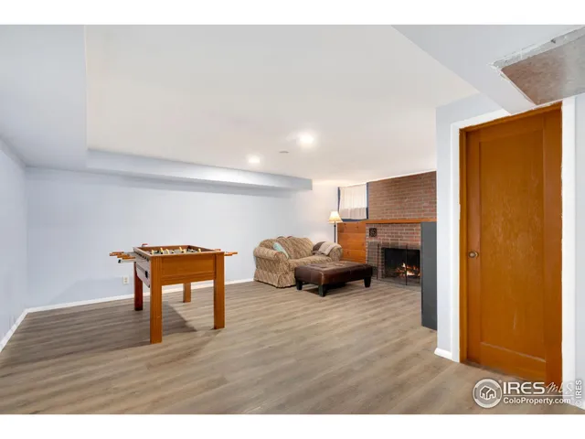 a spacious bedroom with a bed and wooden floor