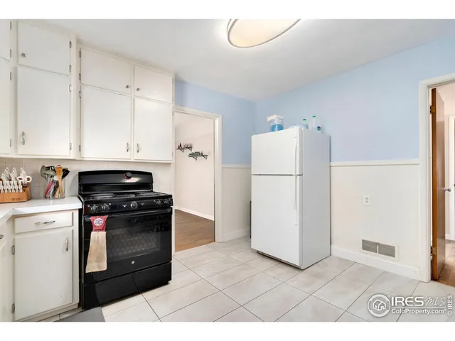 a kitchen with a stove a refrigerator and a sink
