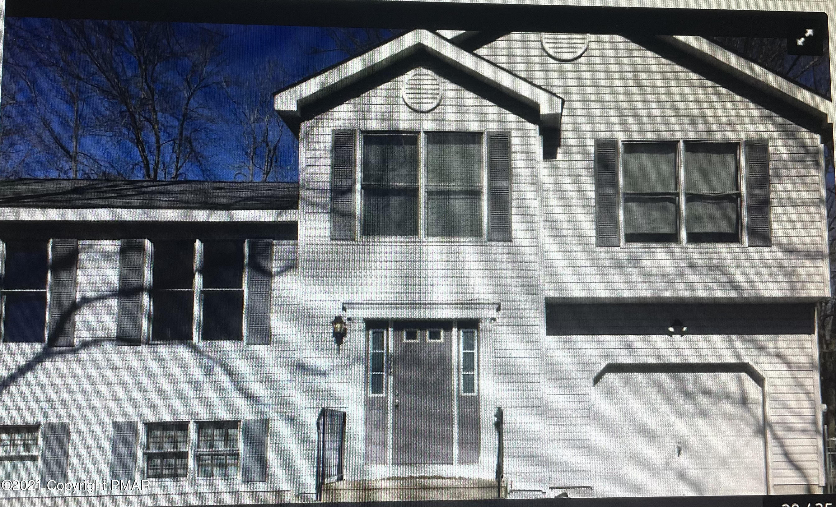 3294 Red Run Road Pocono Summit, PA 18346 - Photo 2 of 36 a front view of a house with glass windows