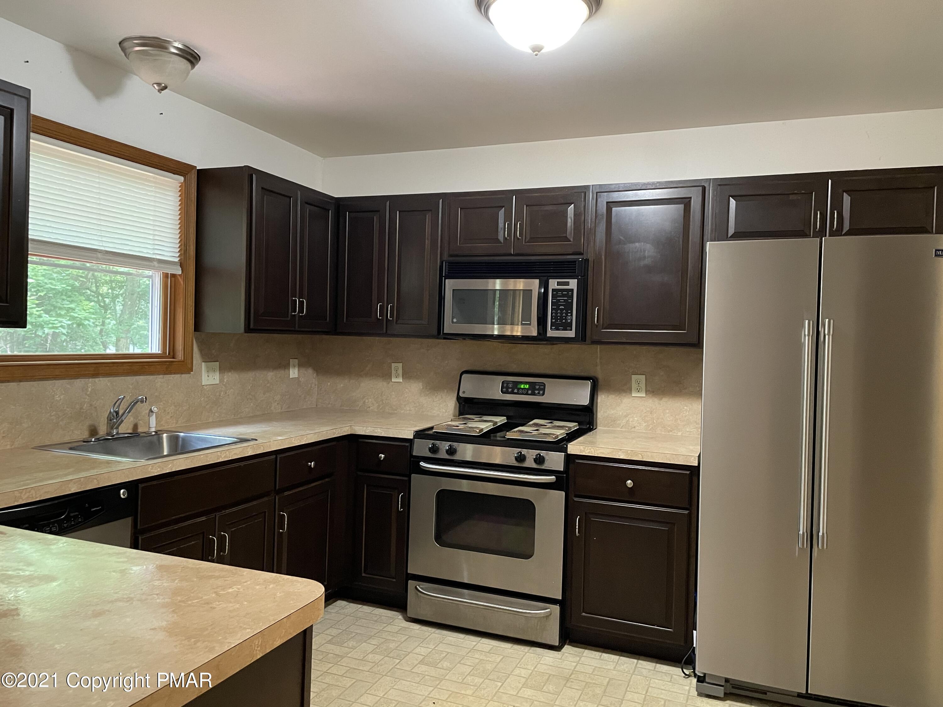 3294 Red Run Road Pocono Summit, PA 18346 - Photo 3 of 36 a kitchen with a sink stove and refrigerator