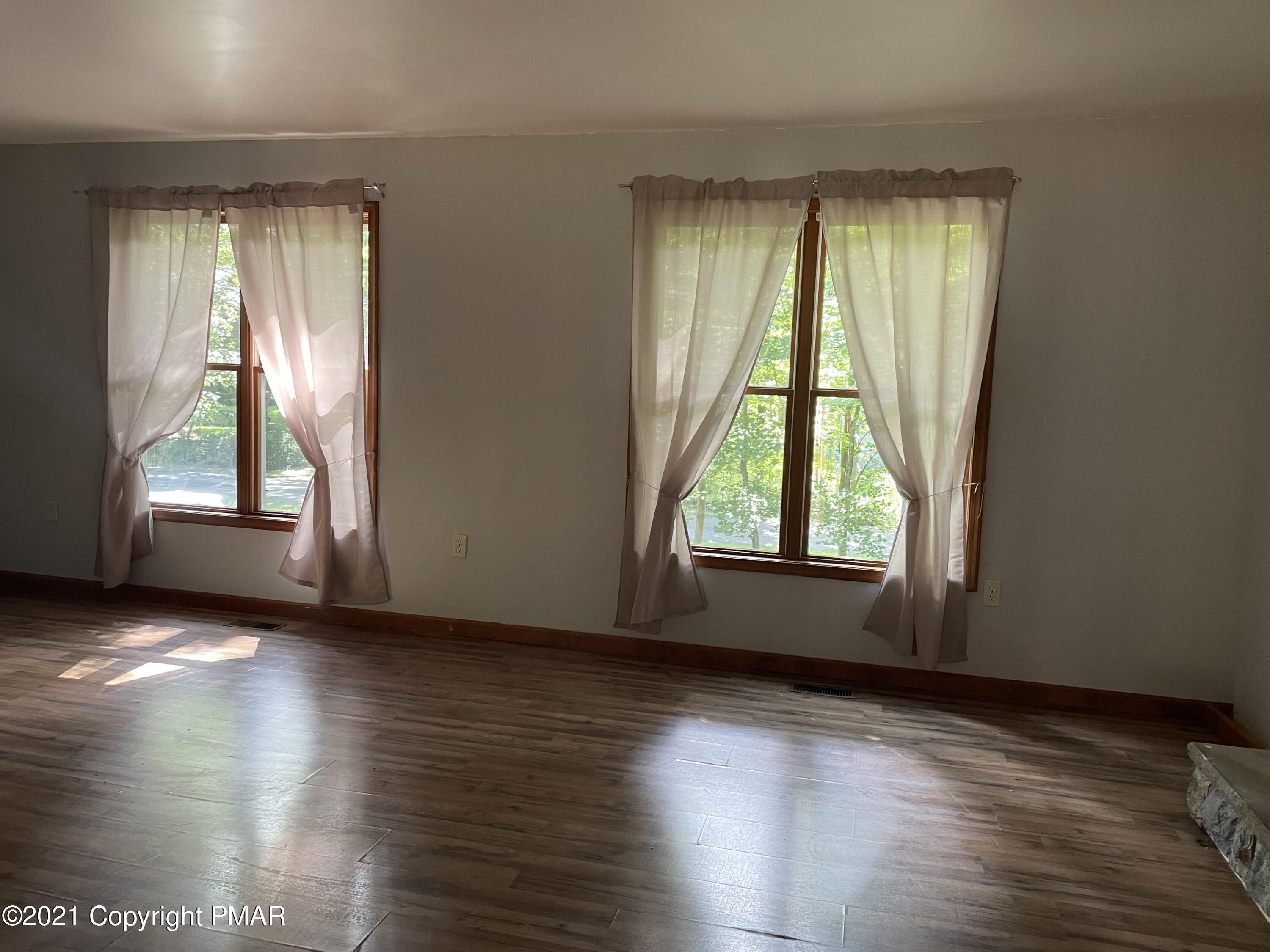 3294 Red Run Road Pocono Summit, PA 18346 - Photo 5 of 36 an empty room with wooden floor and windows