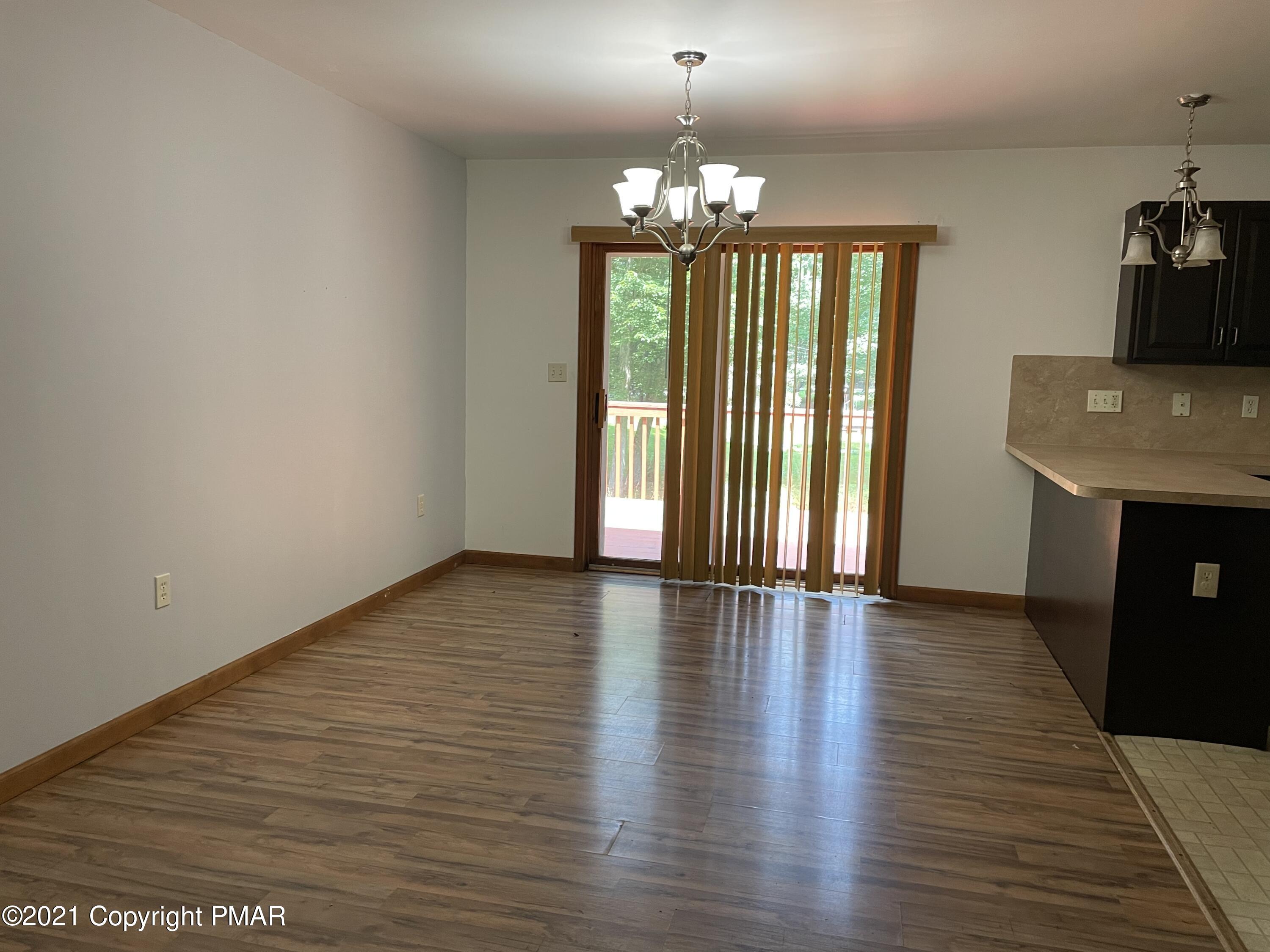 3294 Red Run Road Pocono Summit, PA 18346 - Photo 8 of 36 an empty room with wooden floor and windows