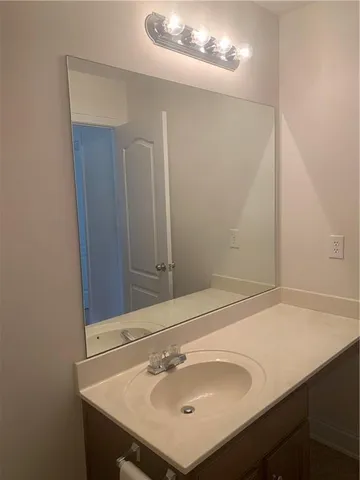 a bathroom with a sink and mirror