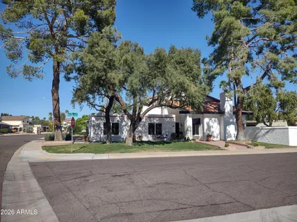 a view of a house with a yard and tree s