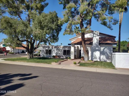 a view of a house with a yard and garage