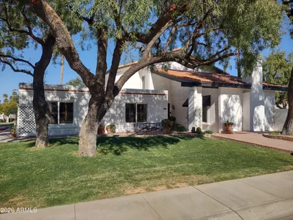 a view of a house with garden and sitting area