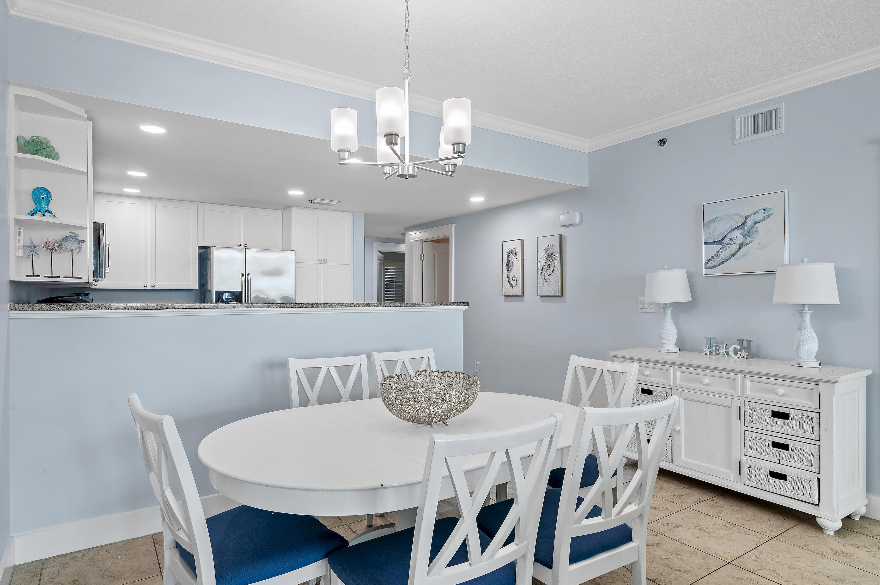 1110 Santa Rosa Boulevard, Unit C500 Fort Walton Beach, FL 32548 - Photo 18 of 59 a kitchen with stainless steel appliances a dining table and chairs