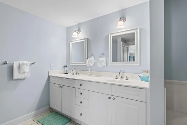 a bedroom with a bed and a flat tv screen on dresser