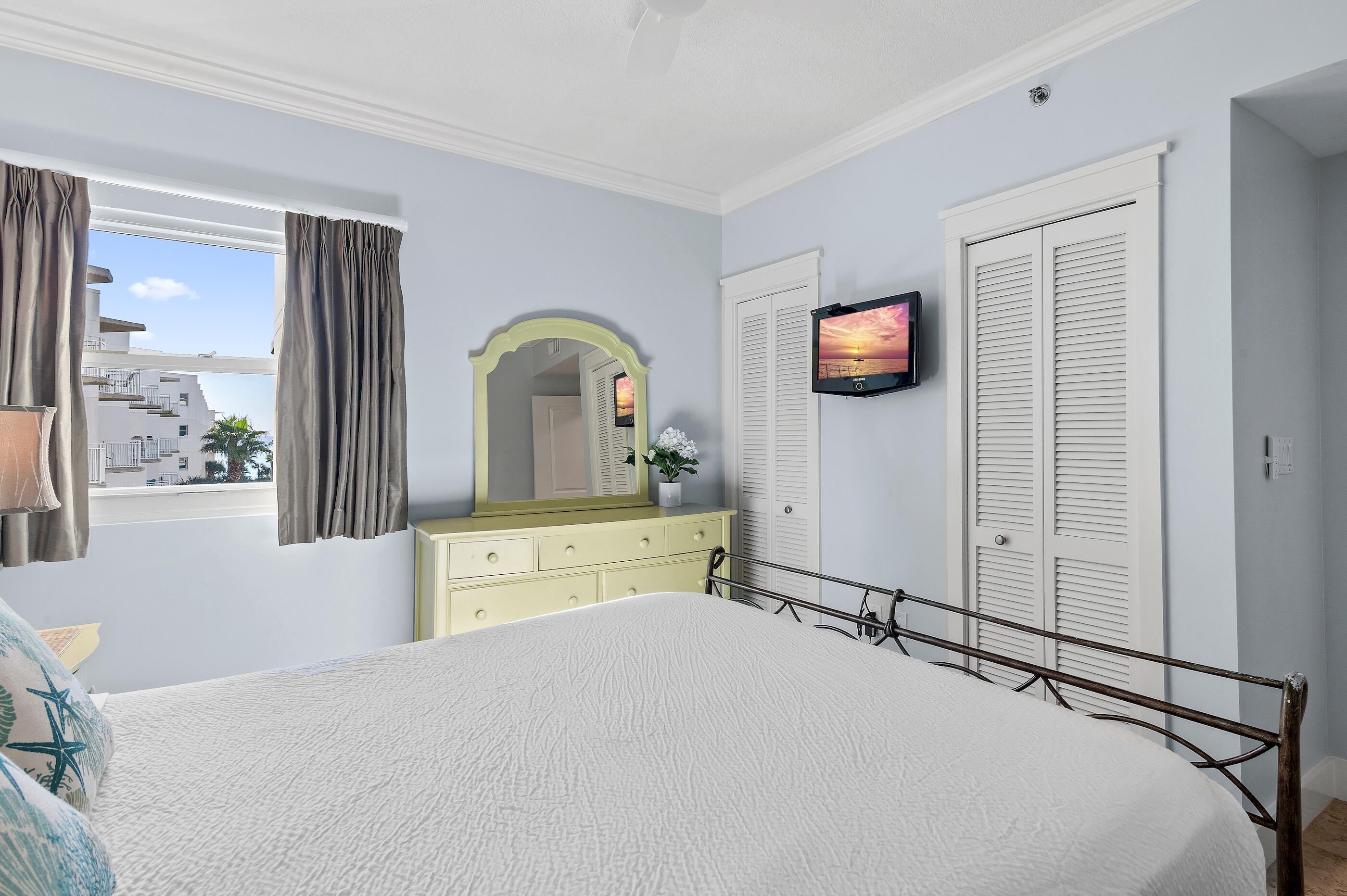 1110 Santa Rosa Boulevard, Unit C500 Fort Walton Beach, FL 32548 - Photo 26 of 59 a bedroom with a bed and a flat tv screen on dresser