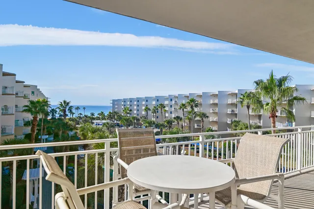 a view of a balcony with table and chairs