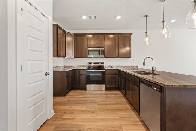 a kitchen with granite countertop a sink and cabinets
