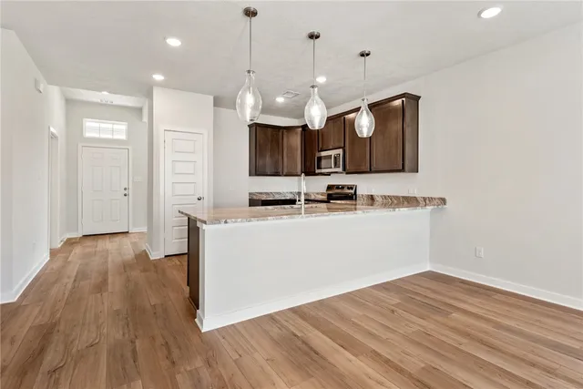 a view of kitchen with wooden floor and window
