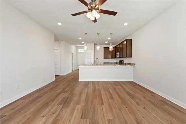 a view of kitchen with refrigerator microwave and stove