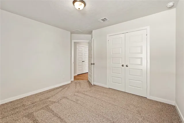 a bathroom with a granite countertop sink a toilet a mirror a bathtub and shower