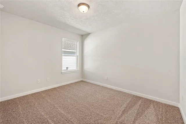 an empty room with closet area