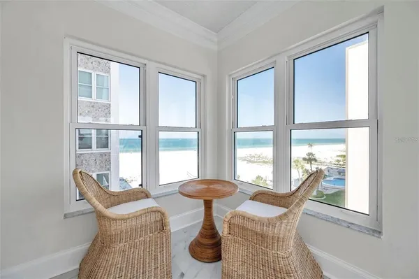 a view of a livingroom with furniture and a large window