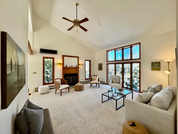 a living room with furniture ceiling fan and a flat screen tv