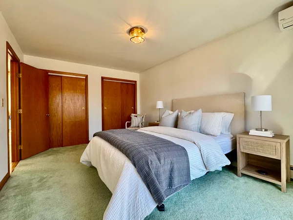 a bedroom with a bed and a lamp