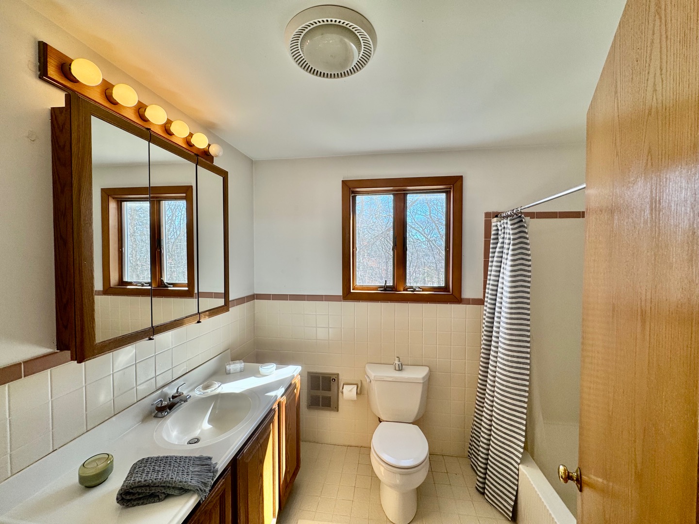 103 Meadow View Road Oak Bluffs, MA 02557 - Photo 18 of 26 a bathroom with a sink a toilet and a mirror