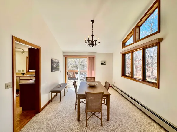 a dining room with furniture window and wooden floor