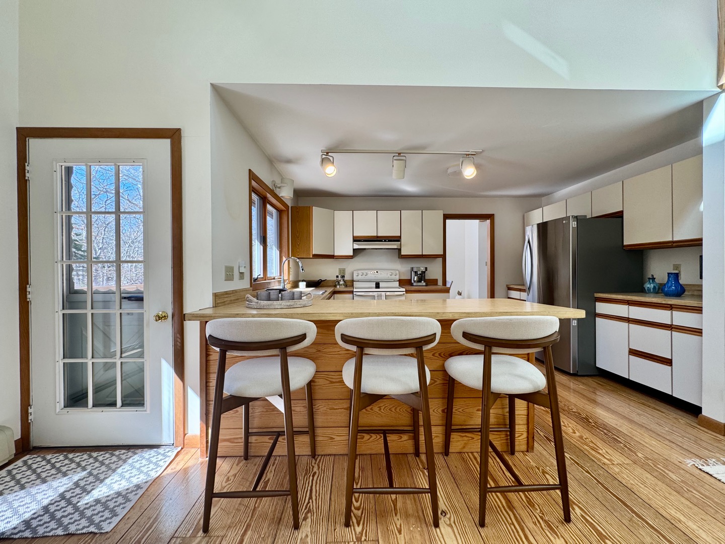 103 Meadow View Road Oak Bluffs, MA 02557 - Photo 5 of 26 a kitchen with a table chairs refrigerator and cabinets