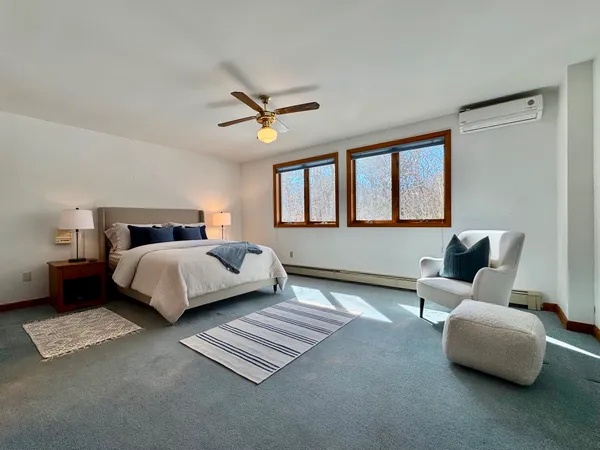 a bedroom with a bed couch and window