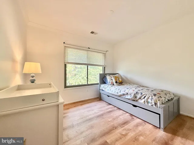 a bed room with a bed and a window