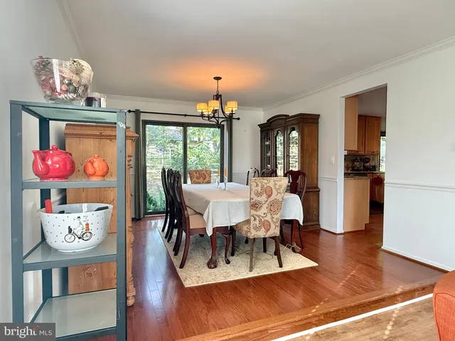 a view of a dining room with furniture wooden floor and chandelier