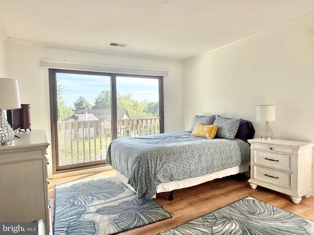a bedroom with a large bed and a large window