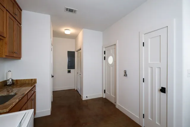 a dining room with furniture large windows and wooden floor