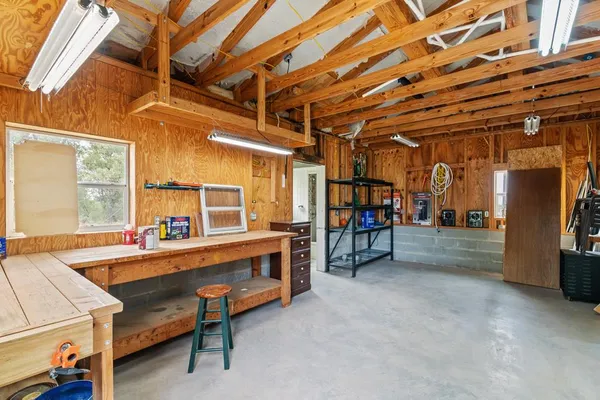 a picture of a room with a white wall and a refrigerator