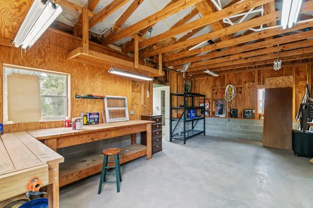 a picture of a room with a white wall and a refrigerator