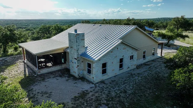 a view of a house with a yard and lake view
