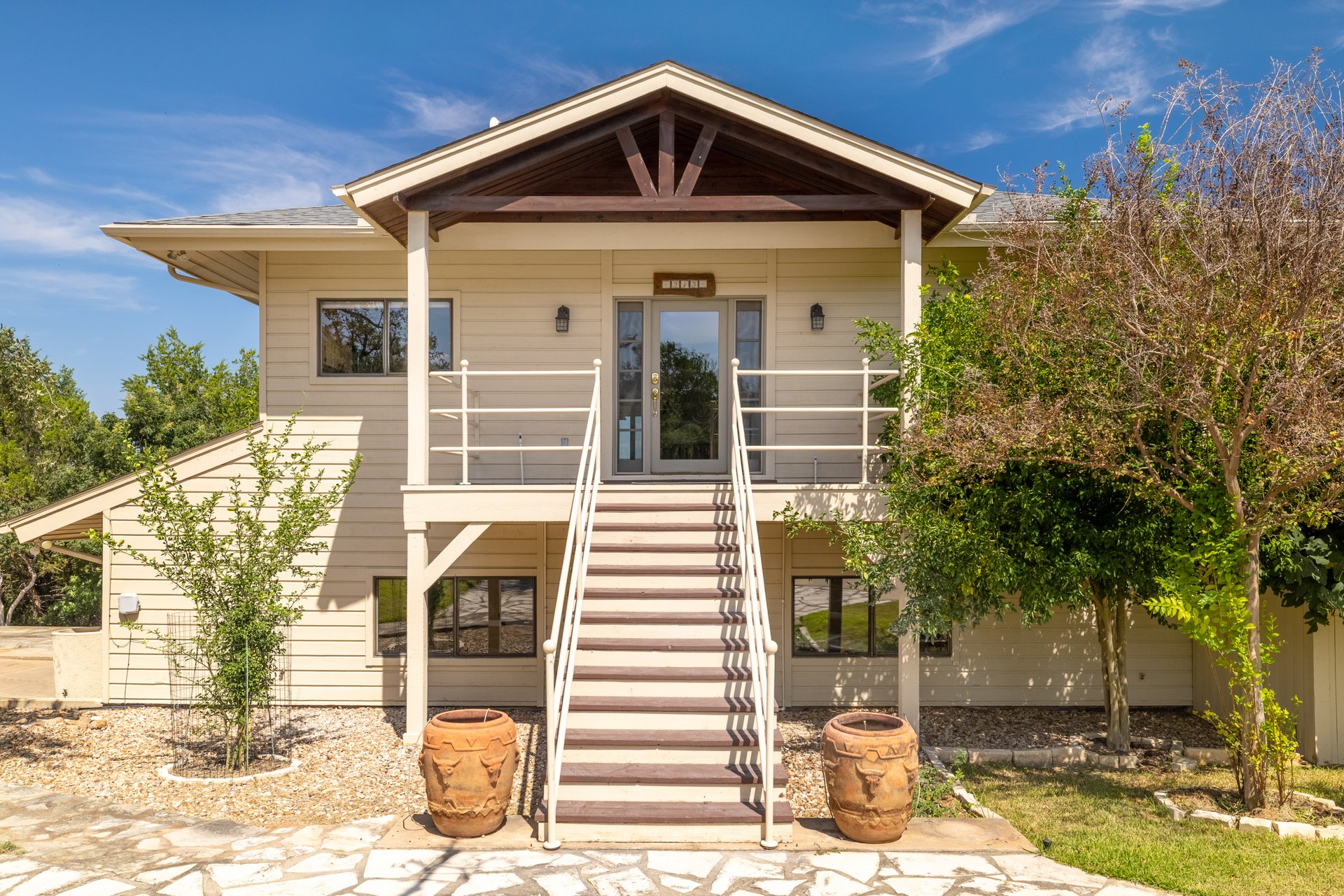 313 Kendall Road Spicewood, TX 78669 - Photo 3 of 34 View of front facade featuring stairs and a patio area