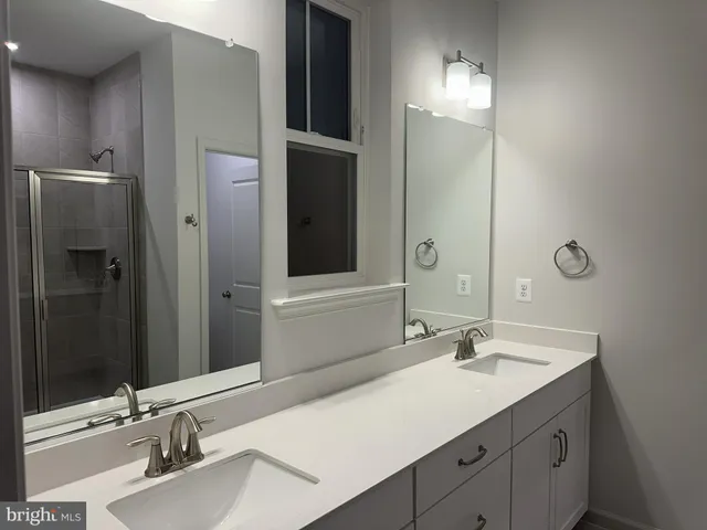a bathroom with a sink double vanity and a mirror
