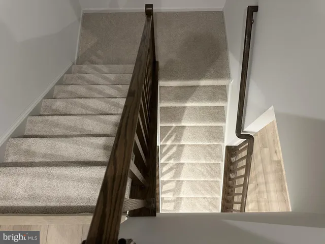 a view of staircase with white walls and a window