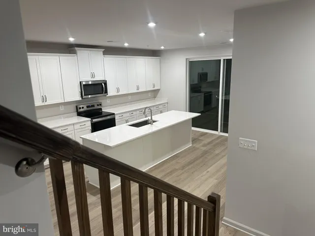 a kitchen with refrigerator cabinets and furniture