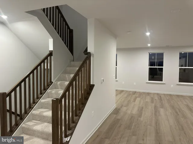 a view of staircase with wooden floor and stairs
