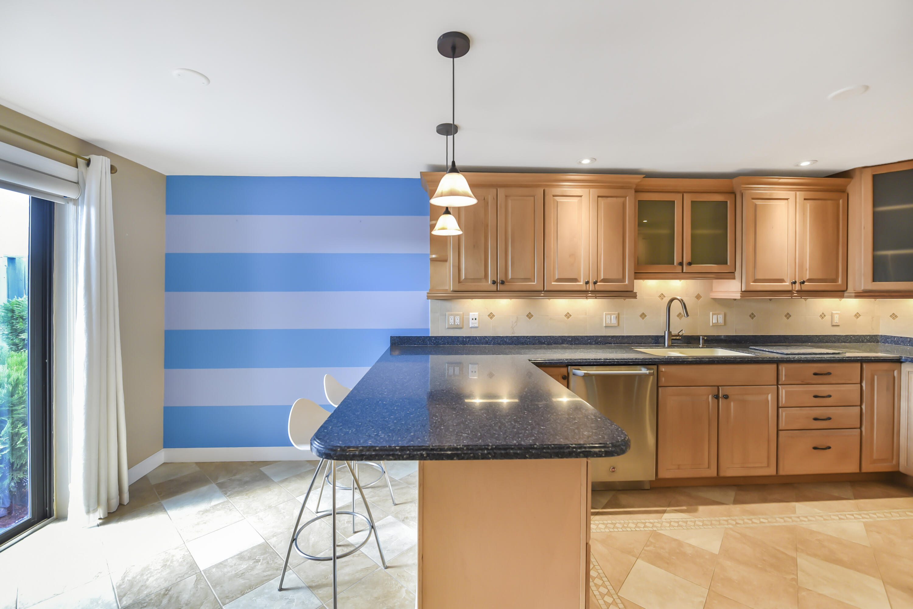 102 Woodland Road Palm Springs, FL 33461 - Photo 13 of 41 a kitchen with a sink a window and cabinets