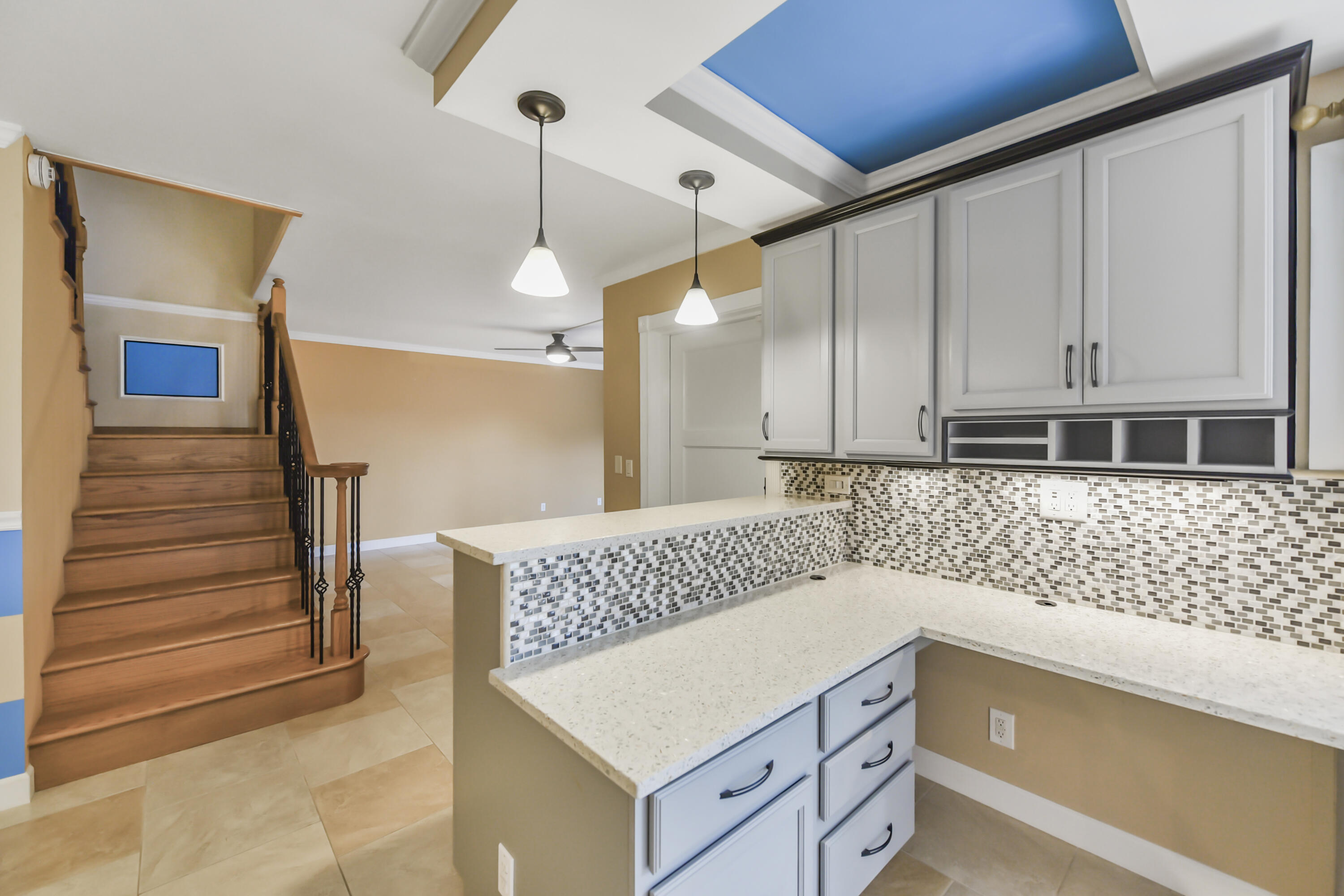 102 Woodland Road Palm Springs, FL 33461 - Photo 17 of 41 a kitchen with a cabinets and chandelier