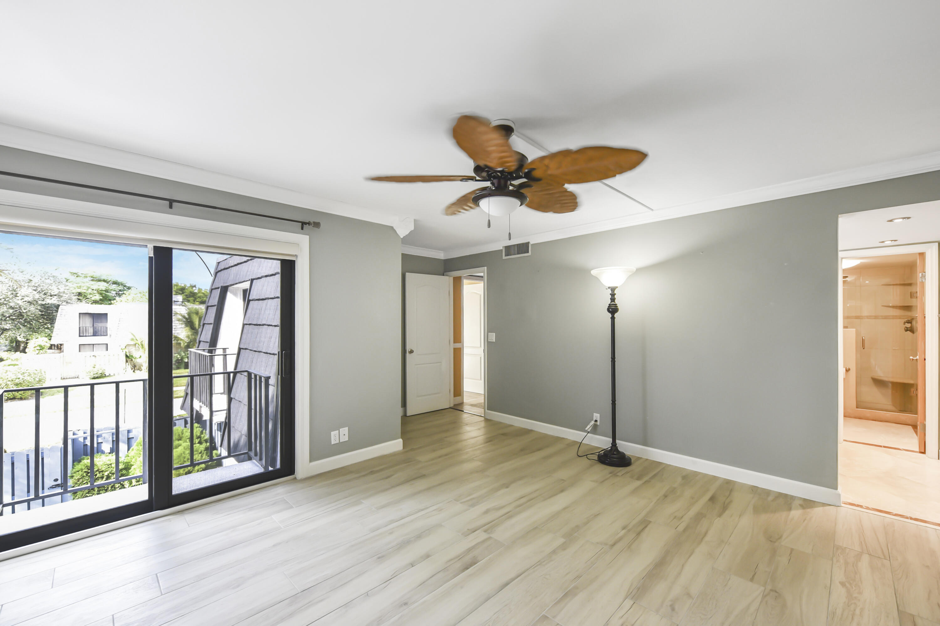 102 Woodland Road Palm Springs, FL 33461 - Photo 30 of 41 wooden floor in an empty room with a window