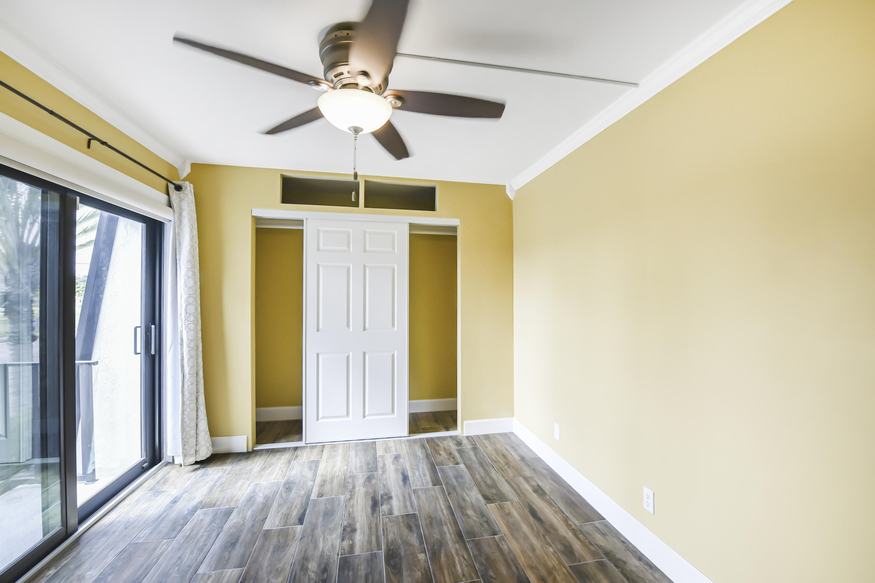 102 Woodland Road Palm Springs, FL 33461 - Photo 33 of 41 a view of an empty room with wooden floor and a window