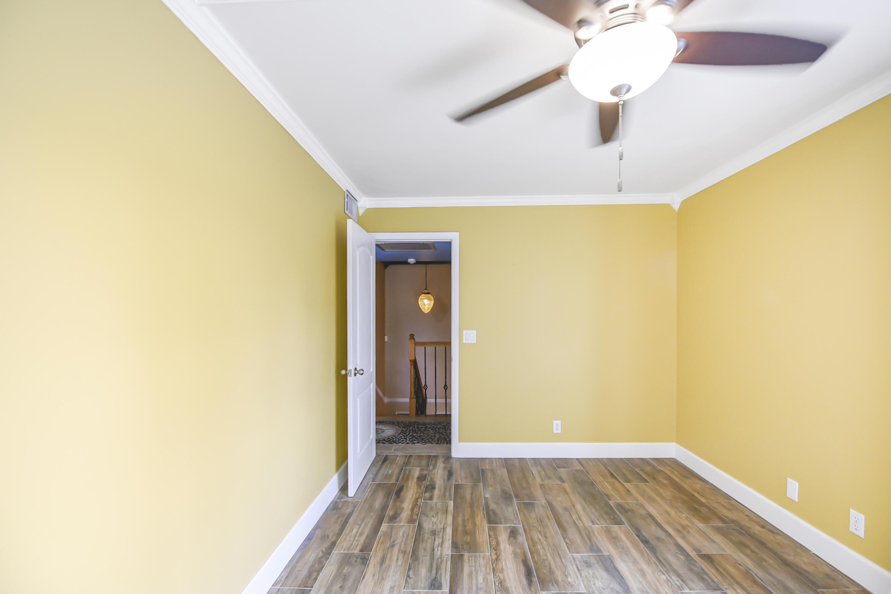102 Woodland Road Palm Springs, FL 33461 - Photo 34 of 41 a view of a hallway with wooden floor and a chandelier