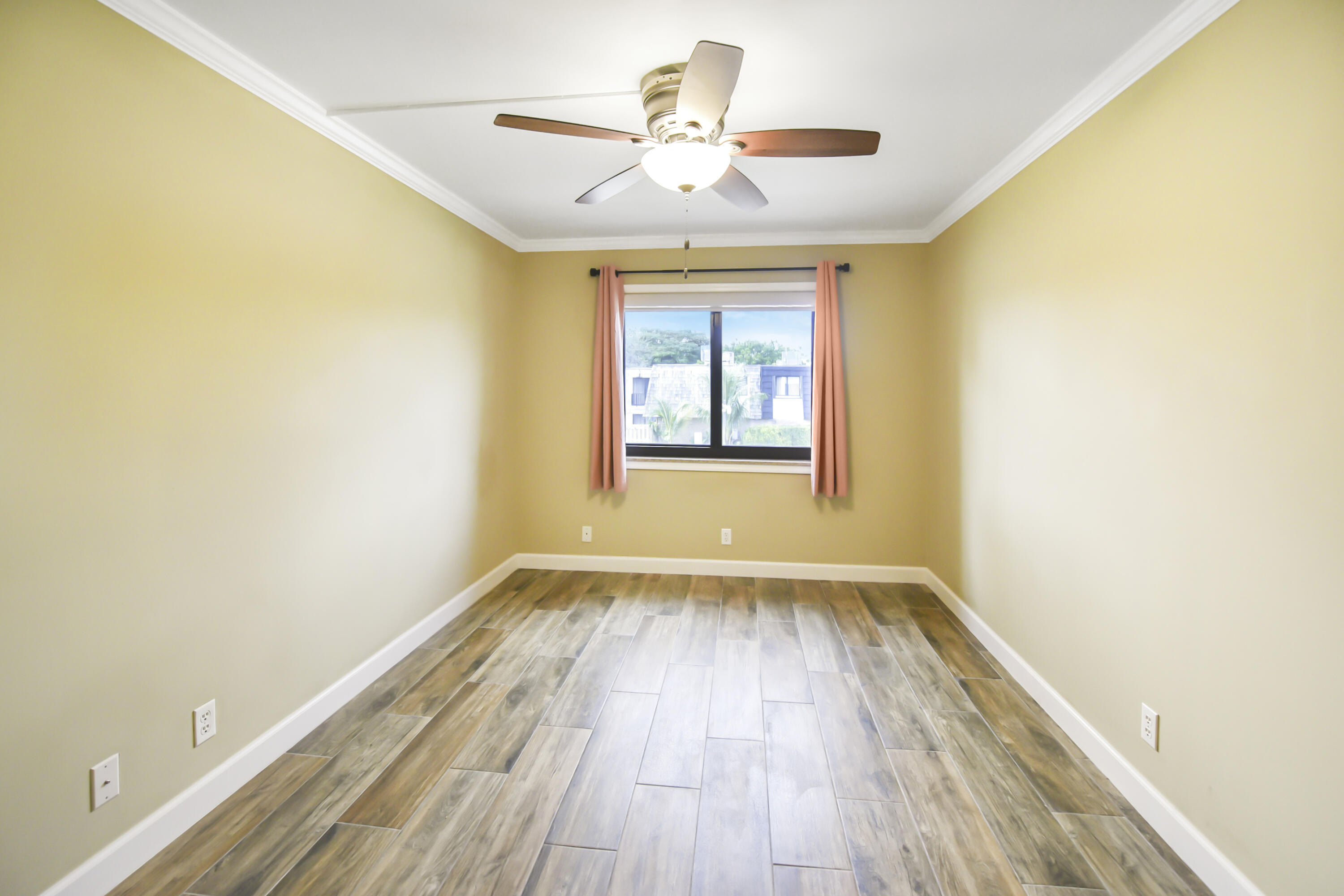102 Woodland Road Palm Springs, FL 33461 - Photo 35 of 41 an empty room with wooden floor and windows